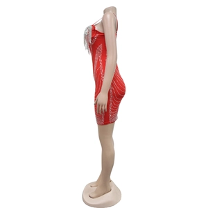 Dettaglio mini abito rosso aderente con frange di strass argento e motivi di cristalli curvi