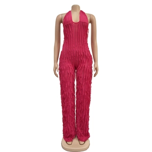 Detailed view of deep V-neck halter jumpsuit with vertical ruffled mesh in rose pink