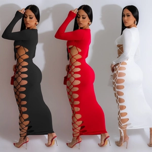 Detail of side cut-out with lace-up ties on slim fit long sleeve maxi dress