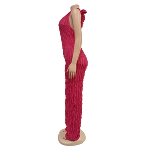 Detail view of pink pleated halter jumpsuit featuring a slim fit and ruffled fabric texture
