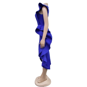 Side view of royal blue sleeveless dress featuring architectural ruffle details