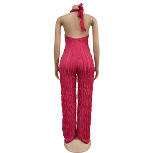 Rear view of rose red halter jumpsuit featuring tiered fringe textures and backless cut