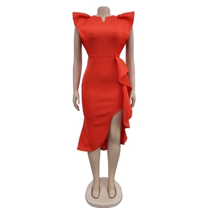 Detail showing ruffled shoulder accents and asymmetric layered slit on orange bodycon dress