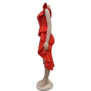 Detail of red one-shoulder dress featuring layered ruffles and asymmetrical hemline