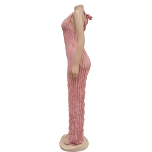 Detail view of pink bodycon jumpsuit featuring textured pleats and halter neck design