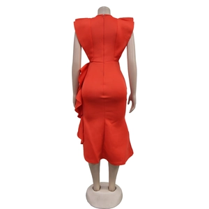 Detail of red sleeveless ruffle dress showing the asymmetric hem and tiered waist frills