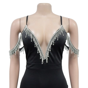 Détail de franges en strass argentés sur le décolleté en V profond d'une robe noire