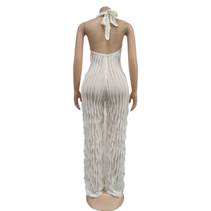 Detail view of white backless jumpsuit with vertical pleated ruffles and halter tie design