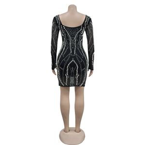 Detailed back view of a black long sleeve mini dress featuring rhinestones and mesh