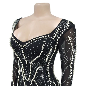 Close-up of black mesh dress featuring elegant pearls and silver rhinestones detail