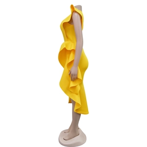 Detail of bright yellow sleeveless dress featuring sculptural side ruffles and asymmetric hem