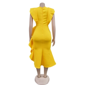 Close-up of yellow slim fit dress featuring back zipper and layered ruffle shoulders