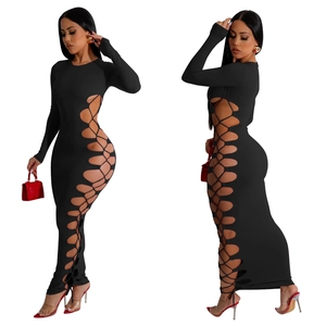Detail of black bodycon maxi dress featuring side cut-out with criss-cross lace-up design