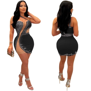 Detail of black bodycon mesh dress featuring sparkling rhinestones and sheer side panels