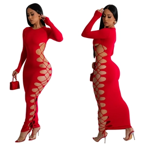 Detail of red bodycon maxi dress featuring side cutout lace-up design and knit fabric