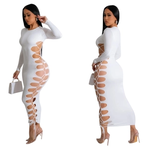 Detail showing side cut-out lace-up design on a white long-sleeve bodycon maxi dress