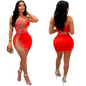 Detail view of red mini bodycon dress with rhinestone mesh patchwork and asymmetric cut