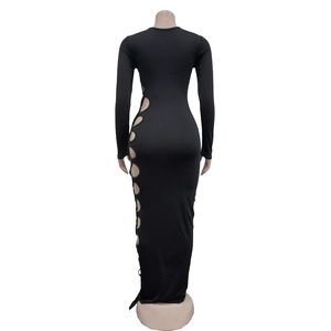 Detail of black slim fit maxi dress featuring side hollow-out rings and knit fabric texture