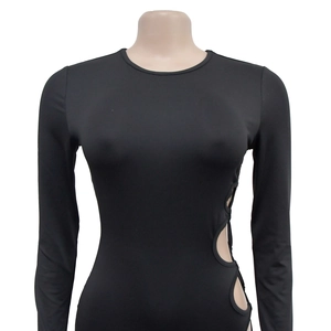 Detail of sexy long-sleeved black top showing side round cut-out design on white background