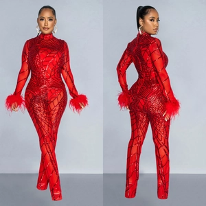 Red sequin jumpsuit for women with sheer mesh panels and elegant feather cuffs