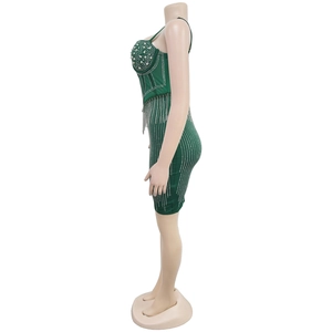 Détail d'une robe vert foncé avec perles, strass et pampilles métalliques de luxe