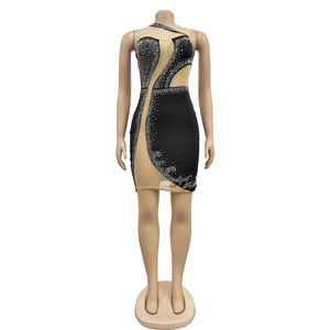 Detail of black mesh bodycon dress with silver rhinestones and asymmetrical sheer panels