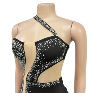 Detail of silver rhinestones and sheer mesh on a black one-shoulder dress for women