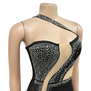Detail of black one-shoulder dress with dense silver rhinestones and mesh panels