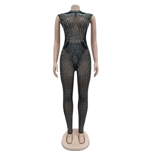 Detail of sheer black mesh jumpsuit with geometric silver rhinestones on mannequin