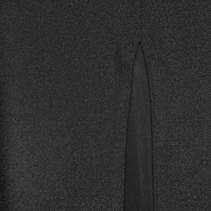 Detailed macro view of black glitter fabric texture and split seam on a women long dress