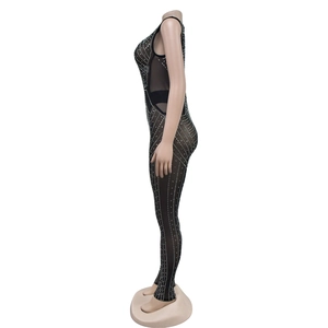 Detailed view of women's mesh jumpsuit with shimmering rhinestones and sleeveless design
