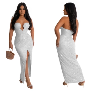 Detail of white sequin maxi dress featuring a high side slit and elegant backless design