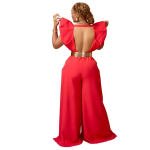 Détail d'une combinaison dos nu rouge avec volants aux épaules et ceinture dorée chic