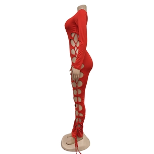 Detail showing side lace-up cutout on a red long sleeve form-fitting jumpsuit