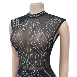 Detail of black mesh jumpsuit with silver rhinestones and metallic stud embellishments