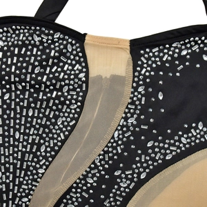 Close-up of sparkling rhinestones and mesh texture on a black sleeveless party dress