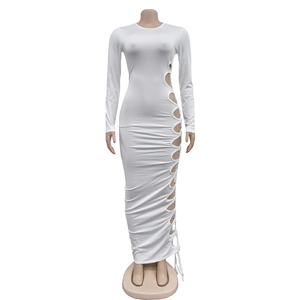 Close-up of white bodycon maxi dress featuring circular cut-outs and lace-up side detail