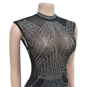 Detail of black mesh jumpsuit with silver rhinestones in geometric pattern on mannequin