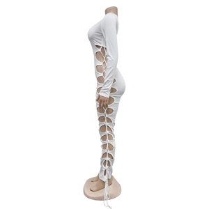 Detail of white long sleeve maxi dress featuring side cut-outs and lace-up drawstring design