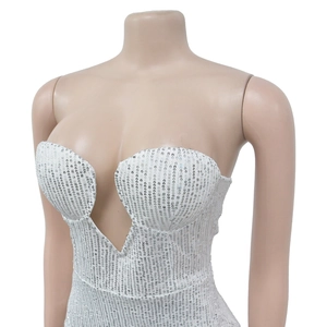 Close-up of sparkling white sequins and deep V-neckline detail on a cocktail dress