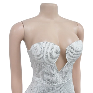 Detail view of white sequined strapless top with V-neckline on a neutral mannequin