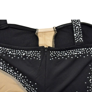 Detail of rhinestone and sequin embellishments on a black mesh sleeveless dress
