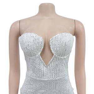 Close-up of shimmering silver sequins on a sexy deep V-neck strapless evening dress