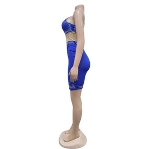 Detail of royal blue bodycon dress with side mesh panels and sparkling rhinestones