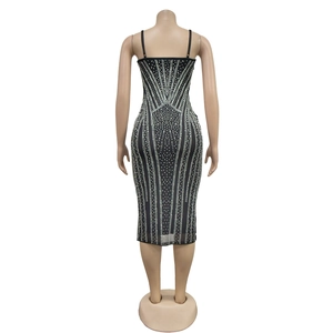 Detail view of the back of a black bodycon dress with silver rhinestones and thin straps