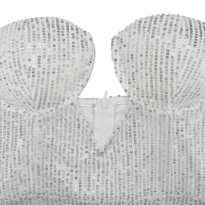 Close-up of white sequin bodice with deep V-neckline and invisible center zipper detail