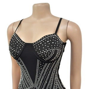 Detailed close-up of a black bodycon dress with sparkling silver rhinestones in stripes