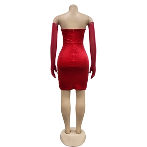 Dettaglio del retro dell'abito in velluto rosso con zip invisibile e guanti di strass