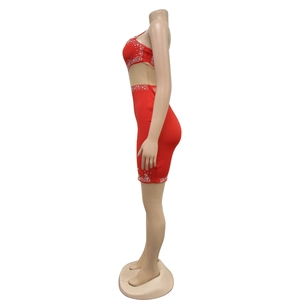 Close-up of red bodycon mesh dress featuring silver rhinestone embellishments on a mannequin
