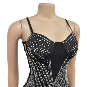 Detail of black camisole dress with sparkling silver rhinestones in geometric pattern